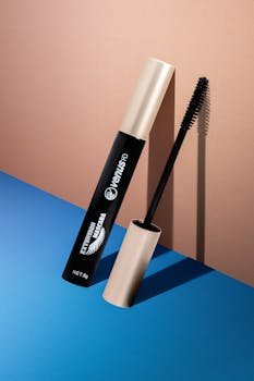 Sleek mascara tube on a minimalist, colorful surface showcasing beauty and elegance.